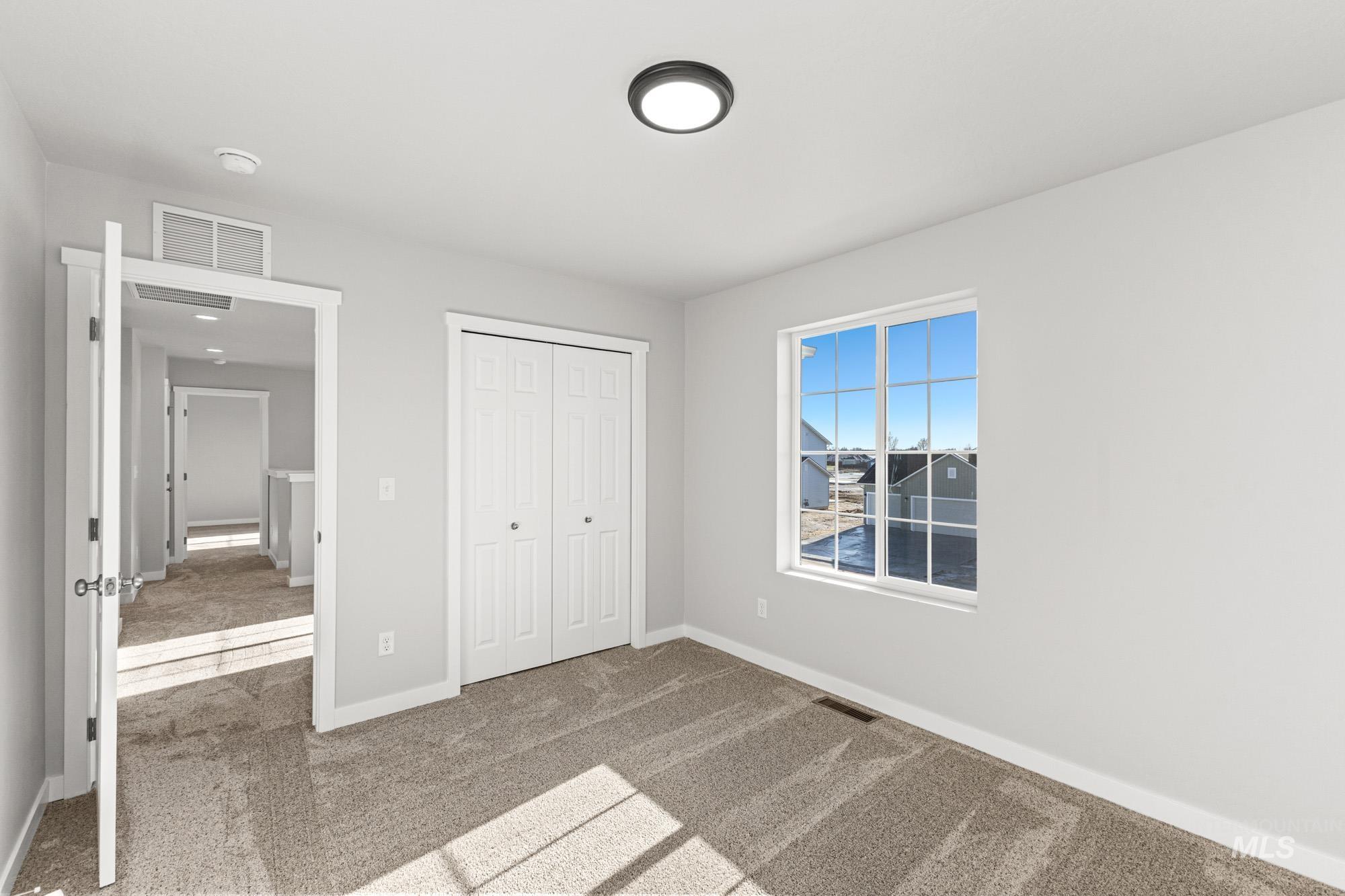 1436 Long Pond Street Middleton, ID 83644 - Photo 13 of 24 Unfurnished bedroom featuring light colored carpet and a closet
