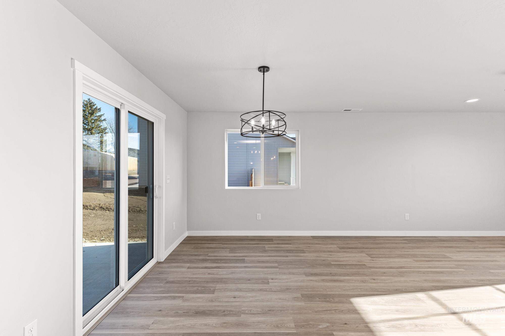 1436 Long Pond Street Middleton, ID 83644 - Photo 7 of 24 Unfurnished dining area with a chandelier and light wood-type flooring
