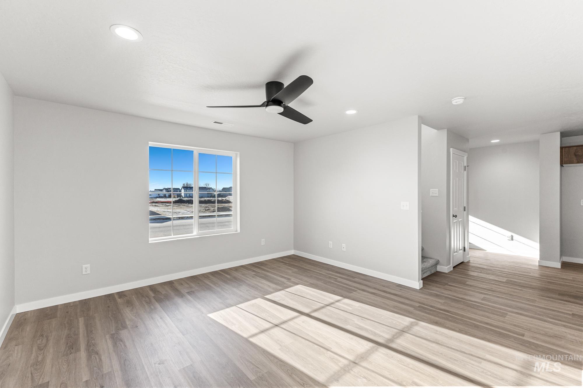 1436 Long Pond Street Middleton, ID 83644 - Photo 9 of 24 Spare room featuring light wood-style flooring, a ceiling fan, and recessed lighting