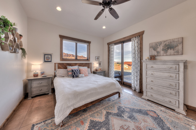 4173 Shadowfax Run, Unit 5 Moab, UT 84532 - Photo 23 of 41 Primary Bedroom featuring access to exterior, a ceiling fan, and multiple windows
