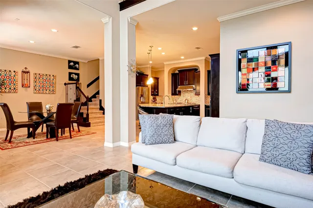 a living room with furniture and kitchen view