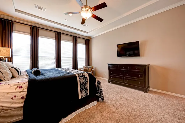 a bedroom with a bed and a television