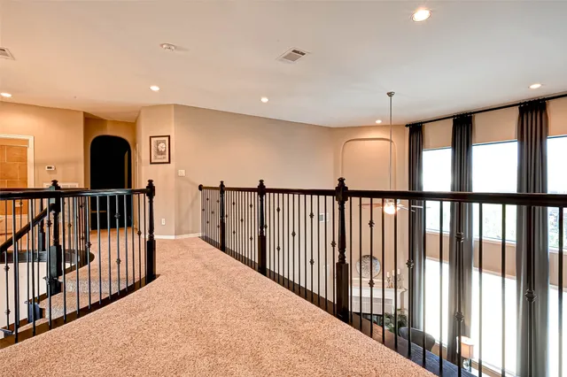 a view of staircase with rug floor and windows