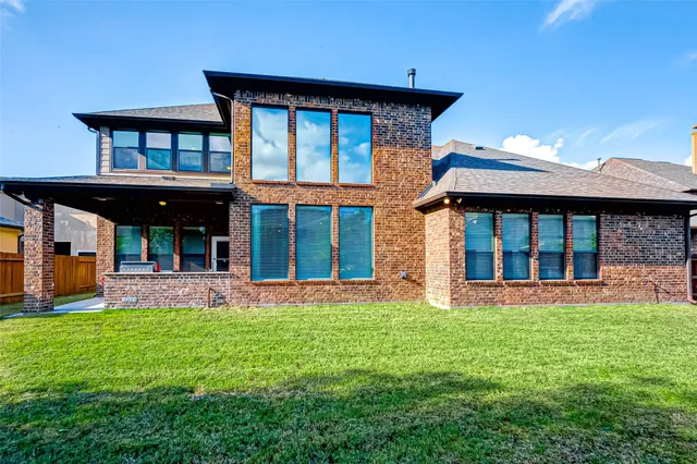 a front view of a house with a yard and porch