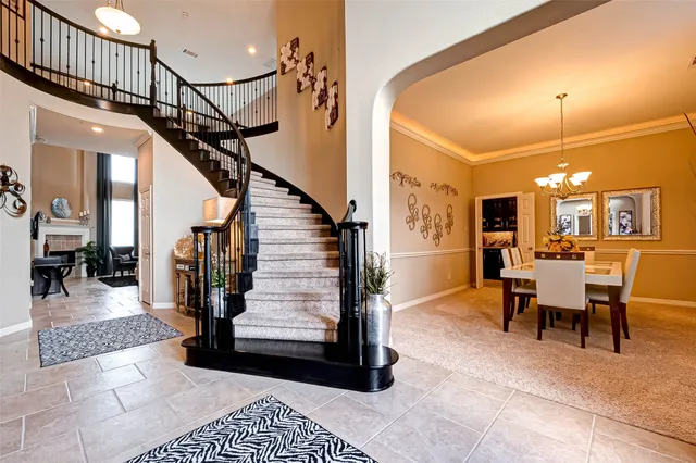 a view of a hallway with dining room and stairs