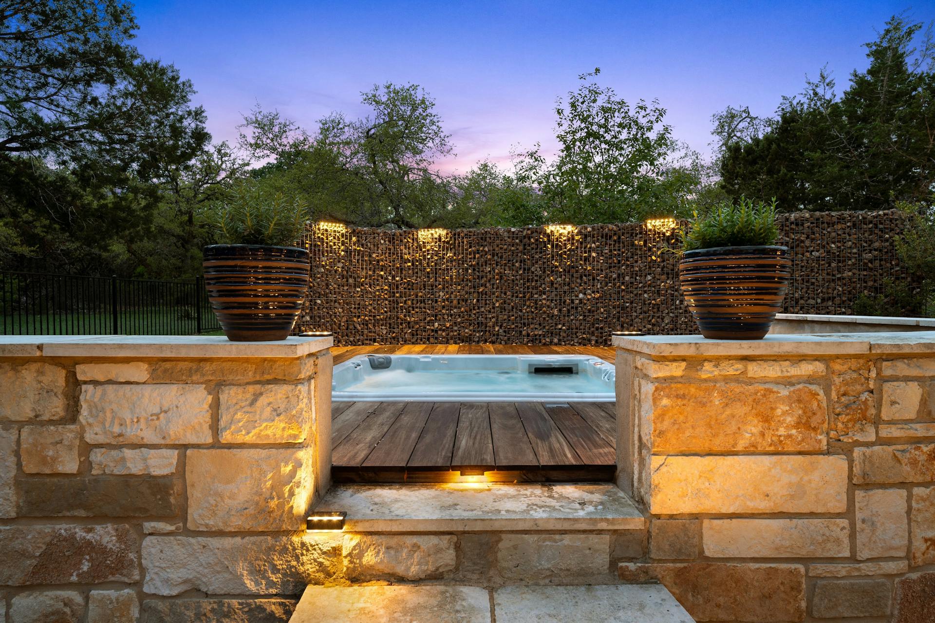 1330 Ranchers Club Lane Driftwood, TX 78619 - Photo 35 of 40 Pool at dusk featuring a hot tub and a patio area