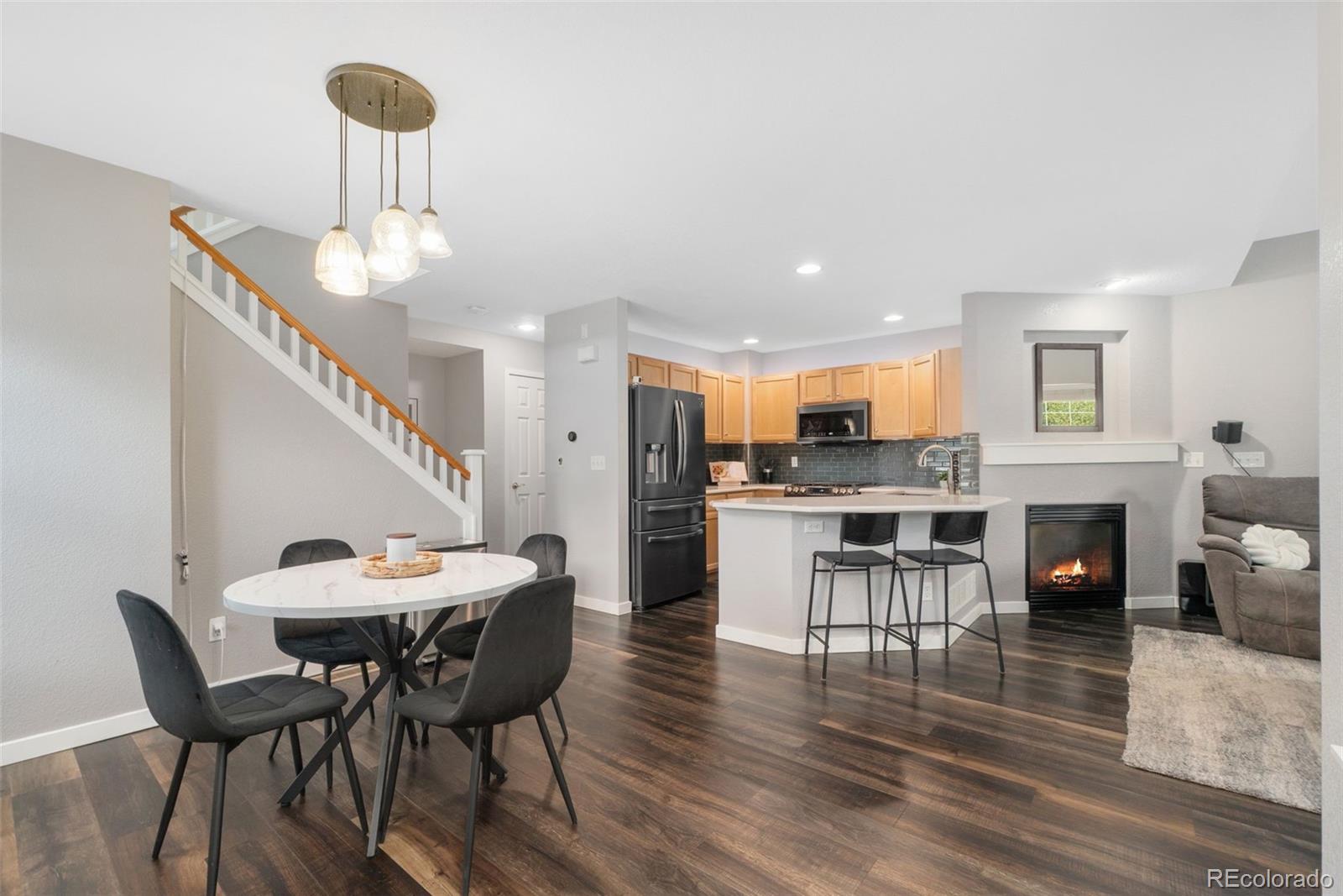 a view of a dining room with furniture a chandelier and wooden floor