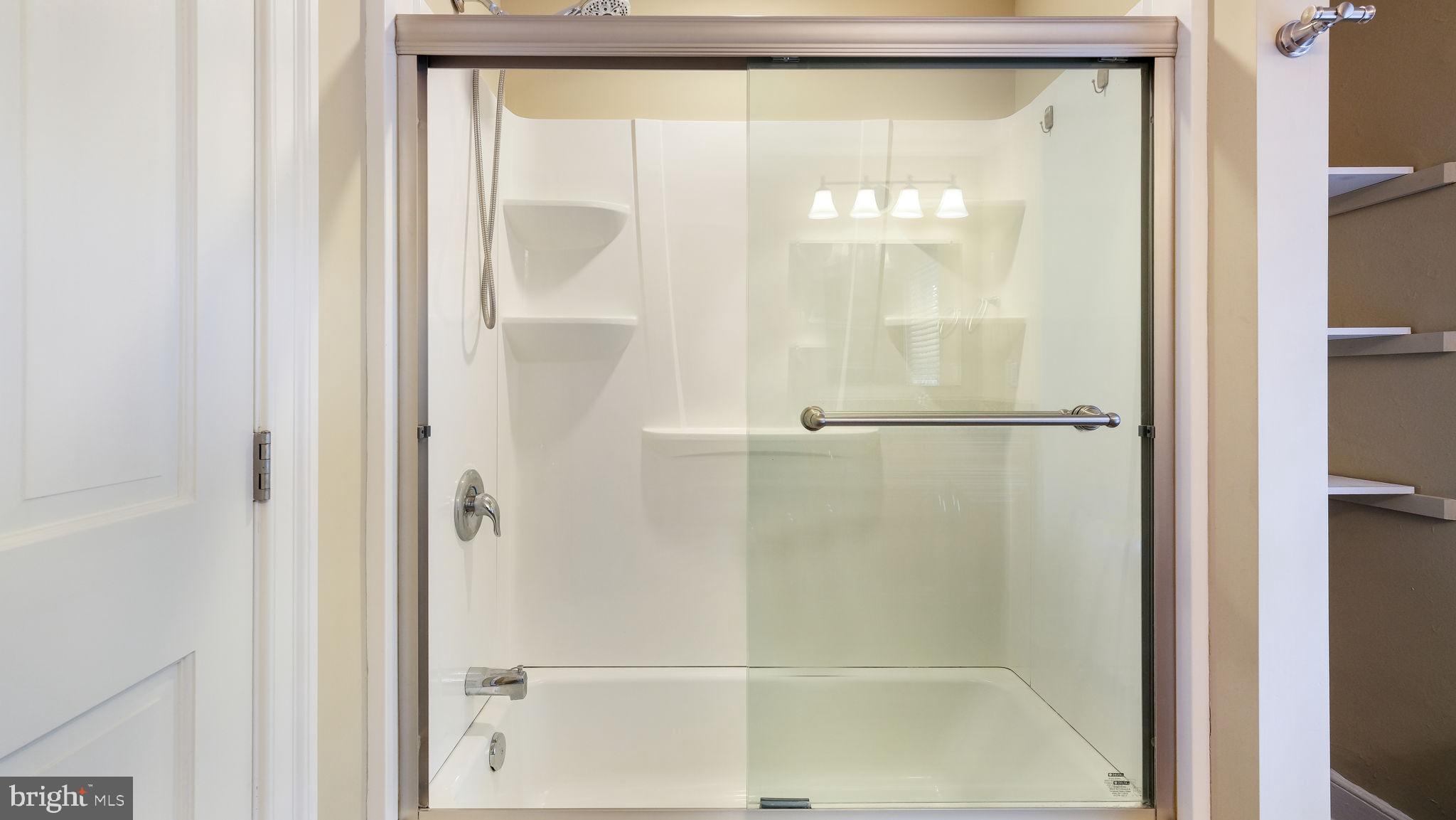 112 East State Street, Unit 6 Doylestown, PA 18901 - Photo 12 of 17 a bathroom with a glass shower door