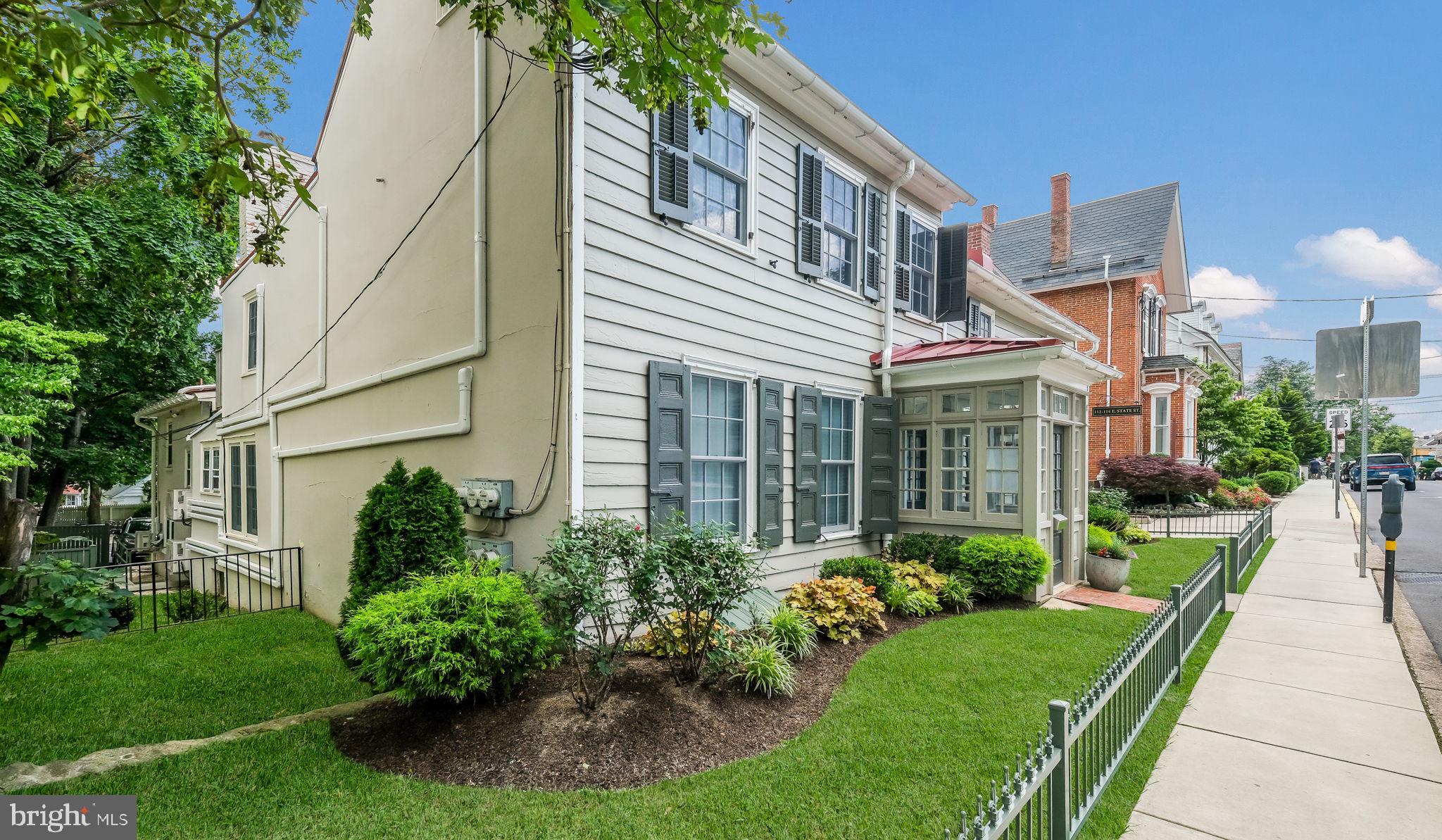 112 East State Street, Unit 6 Doylestown, PA 18901 - Photo 17 of 17 a front view of a house with a yard and potted plants