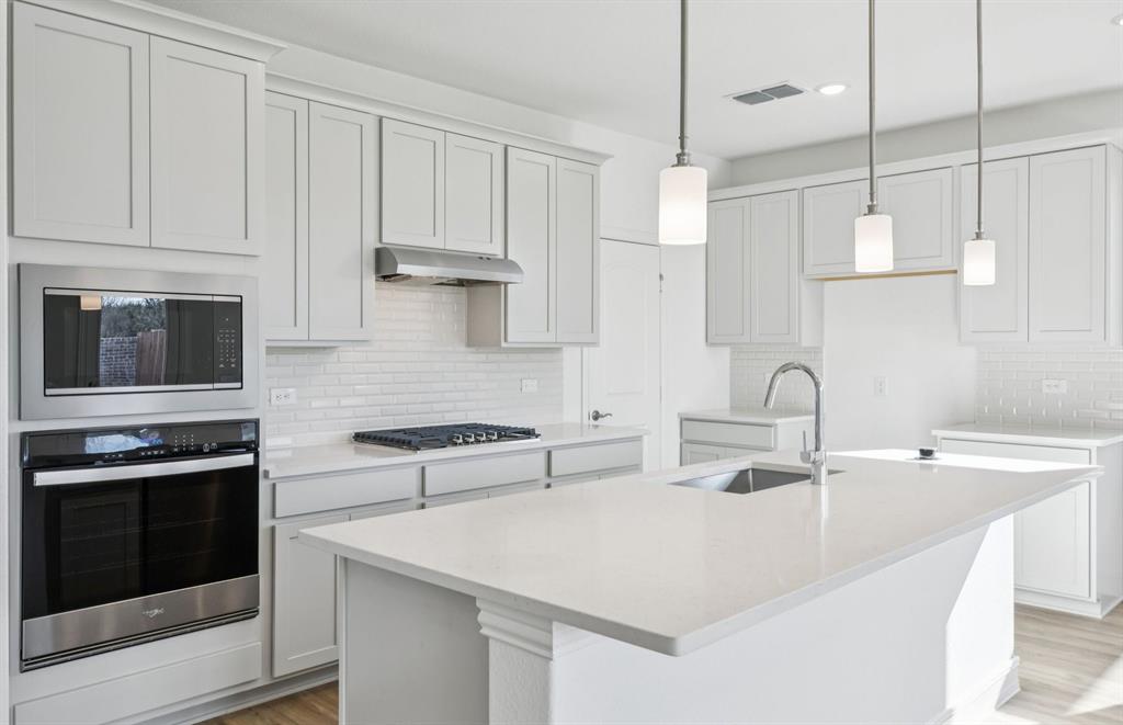 829 Norfolk Lane Godley, TX 76044 - Photo 2 of 21 Open island kitchen with stainless steel appliances