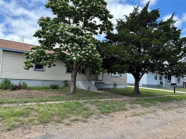 a view of a tree in front of a house