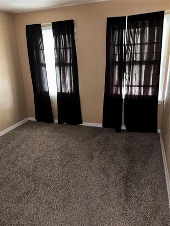 a view of an empty room with windows