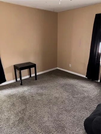 a view of an empty room and room with a window