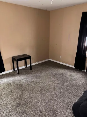 a view of an empty room and room with a window