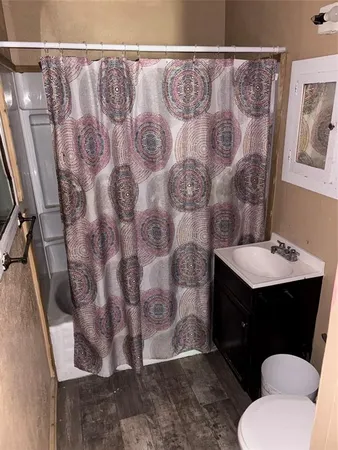 a bathroom with a sink toilet and a mirror