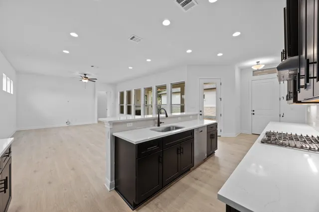 a spacious bathroom with a granite countertop sink and a mirror