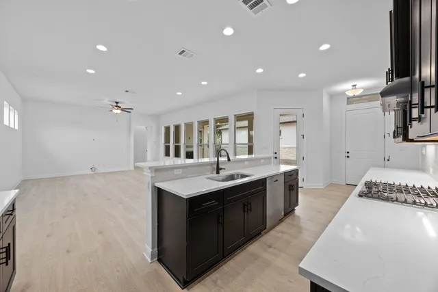 a spacious bathroom with a granite countertop sink and a mirror