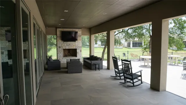 a view of a roof deck with couches and sky view