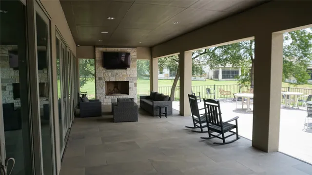 a view of a roof deck with couches and sky view