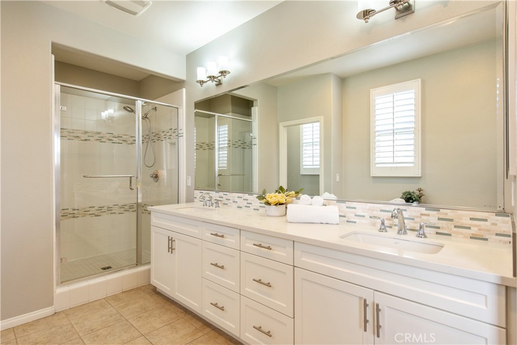 68 Origin Irvine, CA 92618 - Photo 32 of 43 a bathroom with a double vanity sink mirror double and shower