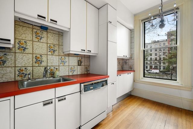 a living room with a fireplace and a wooden floor