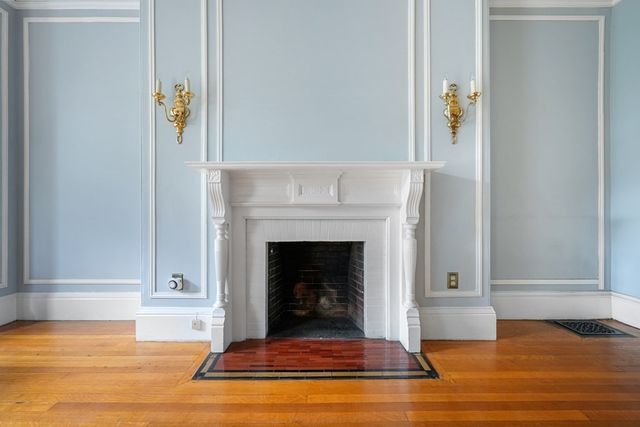 a living room with a fireplace and a rug