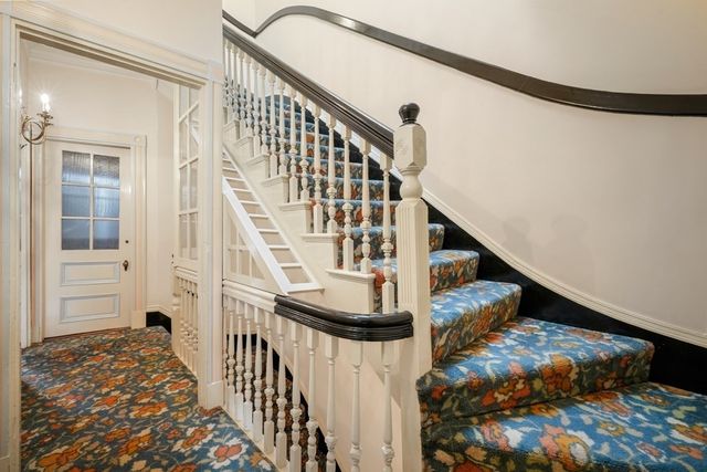 a view of a livingroom with wooden floor and a fireplace