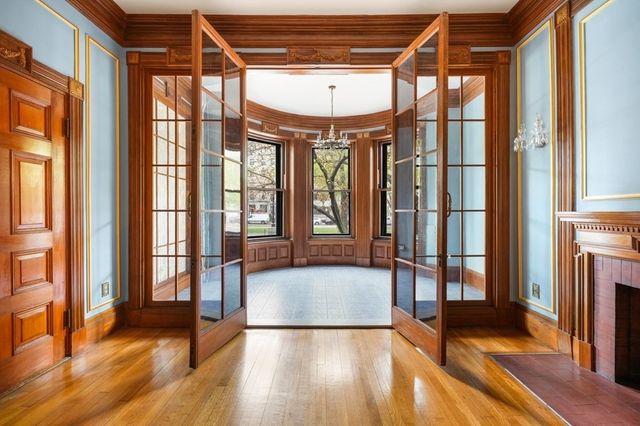 a view of an empty room with a window and a livingroom