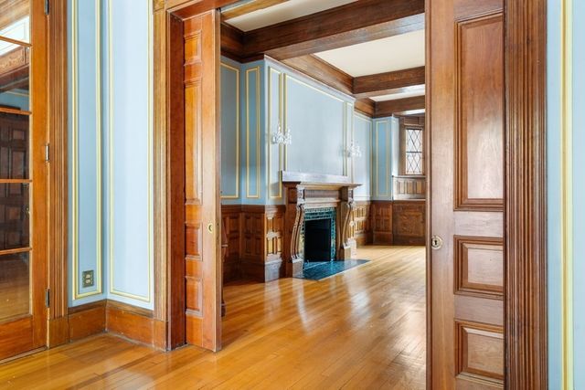 a view of an empty room with a fireplace and a window