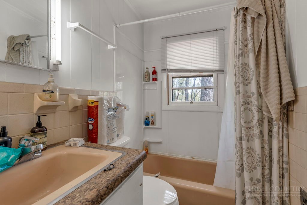 179 Soave Ridge Deep Gap, NC 28618 - Photo 18 of 31 a bathroom with a granite countertop sink a toilet and shower