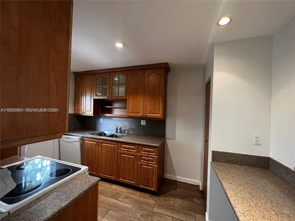a kitchen with stainless steel appliances granite countertop a sink stove and cabinets