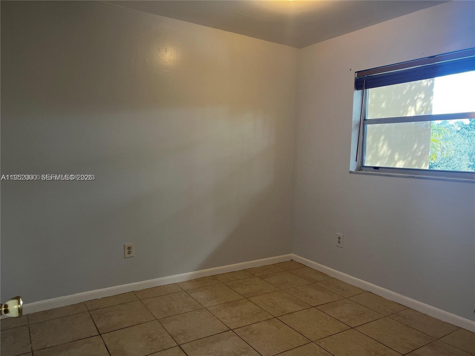 4111 Stirling Road, Unit 308 Fort Lauderdale, FL 33314 - Photo 14 of 32 an empty room with a window