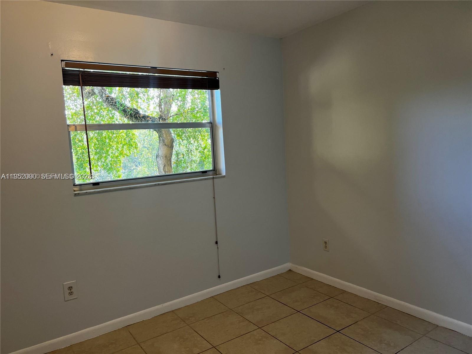 4111 Stirling Road, Unit 308 Fort Lauderdale, FL 33314 - Photo 18 of 32 an empty room with a window