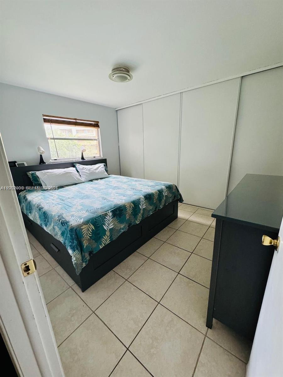 4111 Stirling Road, Unit 308 Fort Lauderdale, FL 33314 - Photo 20 of 32 a bedroom with a bed and a cabinets