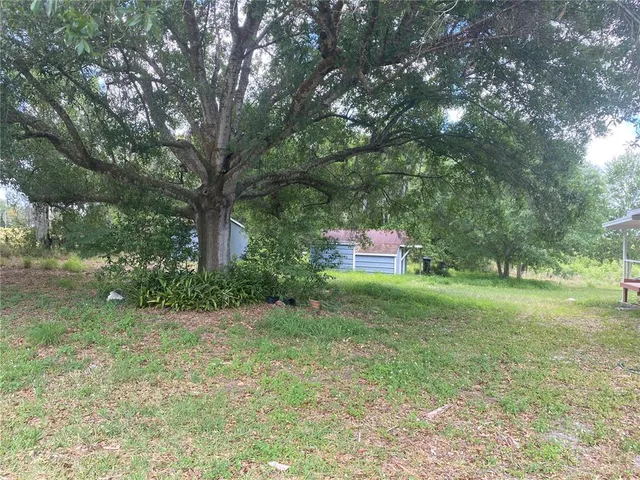 a backyard of a house with outdoor seating and green space