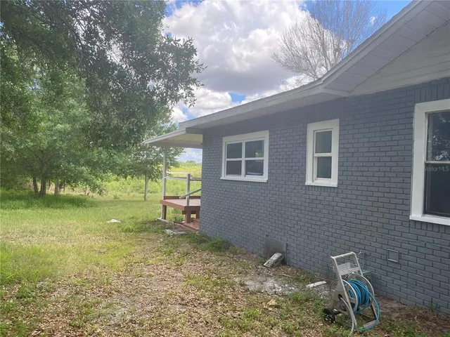 a backyard of a house with lots of green space