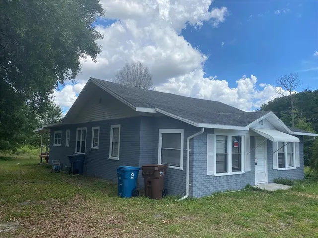 a view of house with backyard