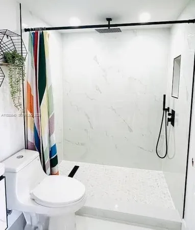 a bathroom with a sink a toilet and a shower