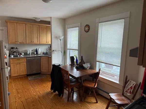 a kitchen with a table chairs sink and cabinets