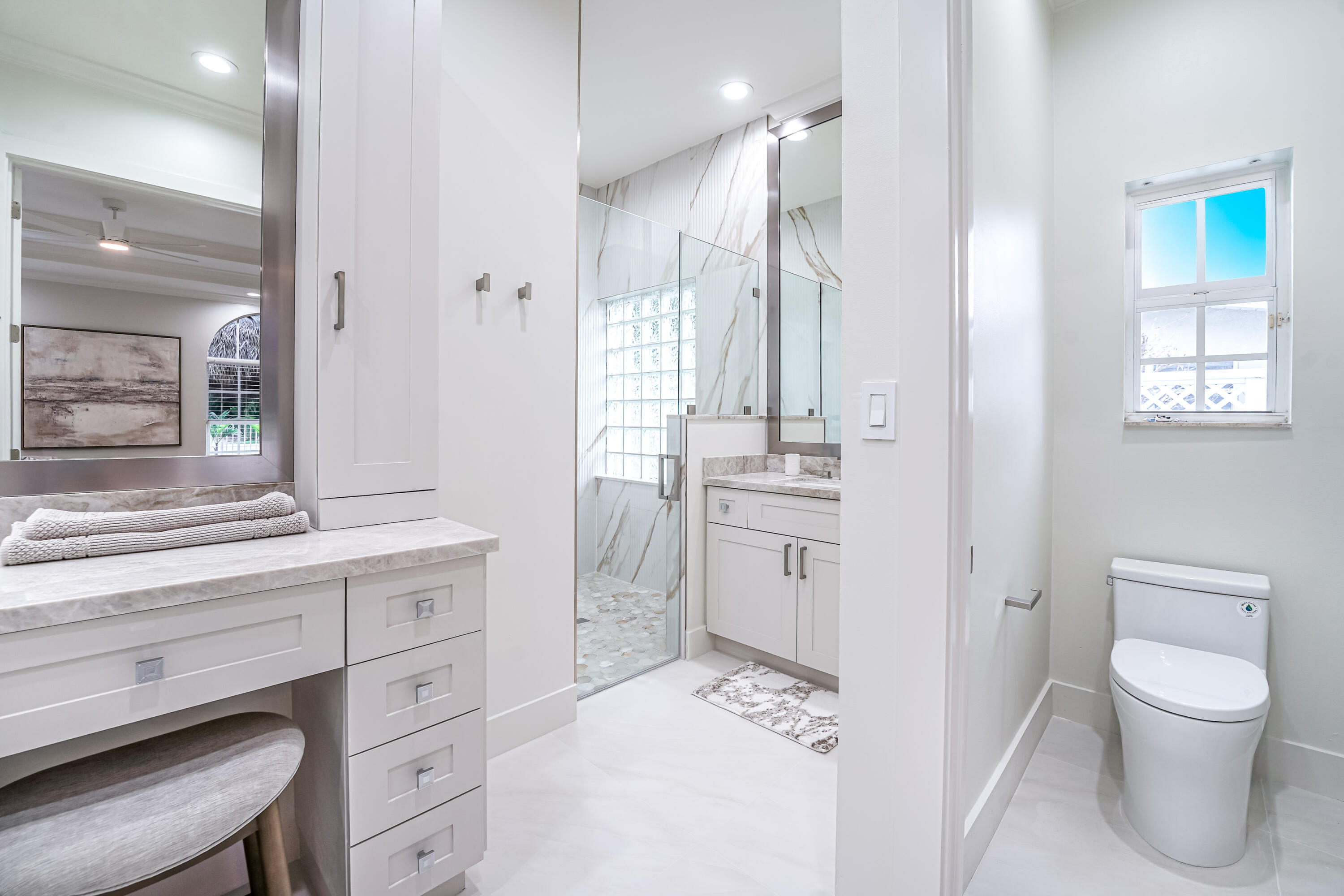 749 Northeast 71st Street Boca Raton, FL 33487 - Photo 19 of 43 a bathroom with a toilet sink and a mirror