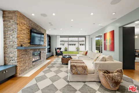 a living room with fireplace furniture and a flat screen tv