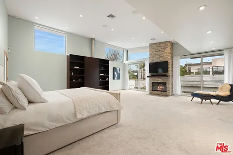 a bedroom with a bed and a flat screen tv