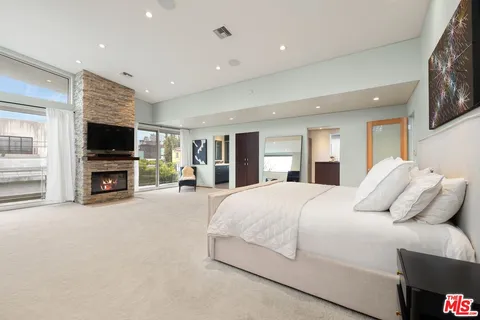 a spacious bathroom with a double vanity sink a mirror and a shower