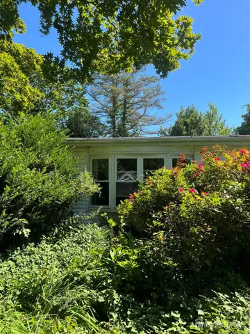 front view of a house with a garden