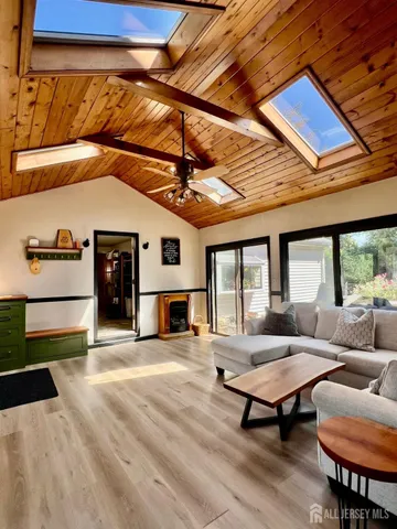 a living room with furniture a fireplace and city view