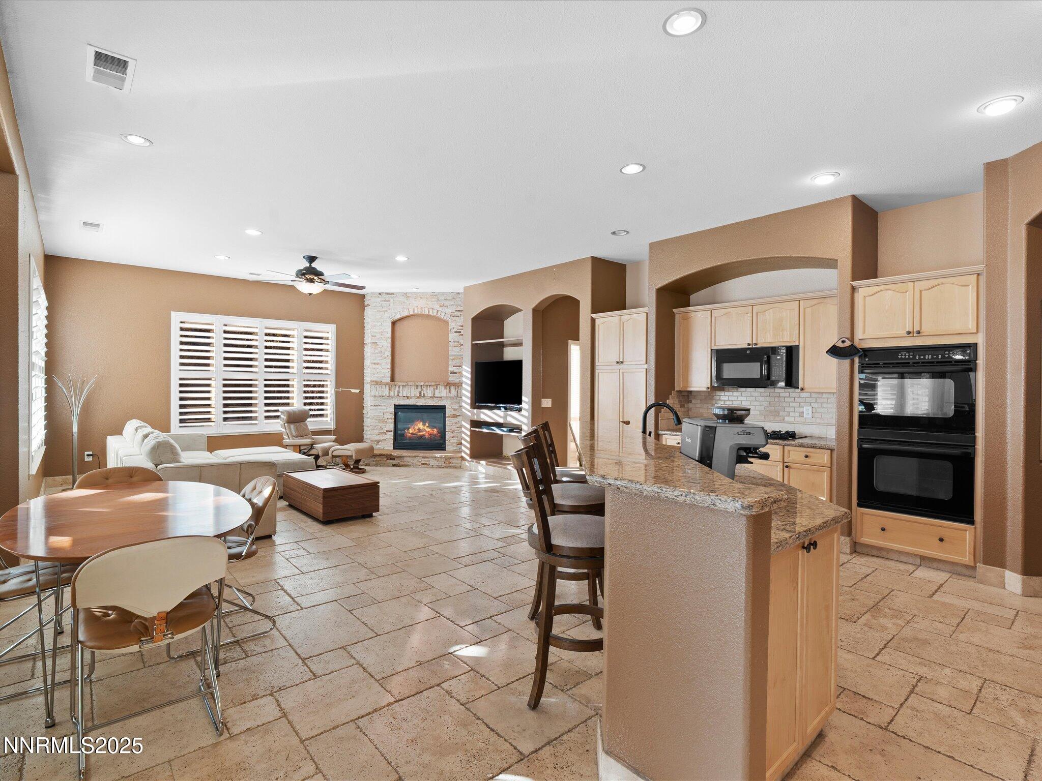 5519 New Mexico Court Reno, NV 89511 - Photo 18 of 60 a living room with fireplace furniture and a large window