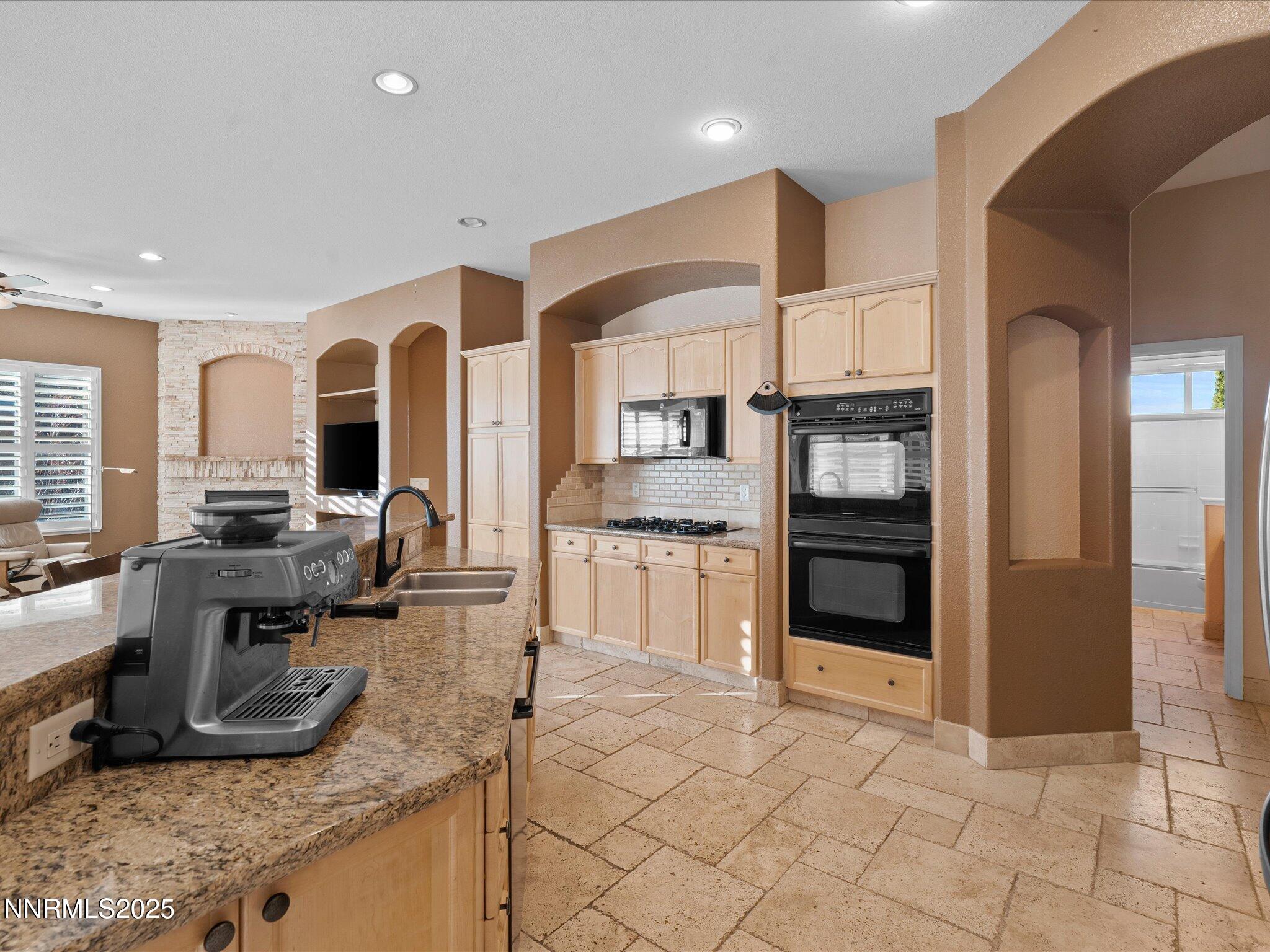 5519 New Mexico Court Reno, NV 89511 - Photo 19 of 60 a kitchen with stainless steel appliances granite countertop a stove and a sink