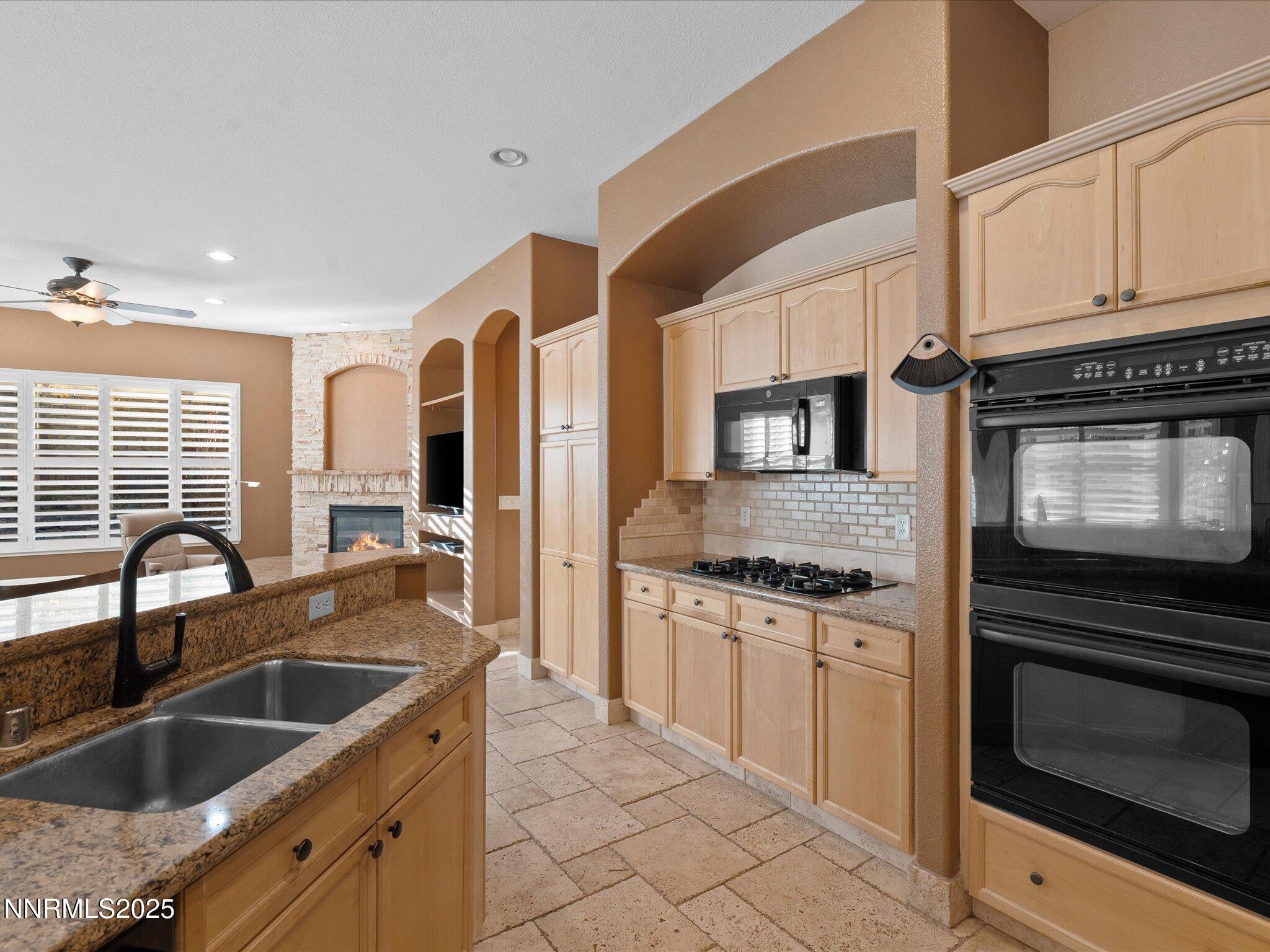 5519 New Mexico Court Reno, NV 89511 - Photo 20 of 60 a kitchen with granite countertop a sink stainless steel appliances and cabinets