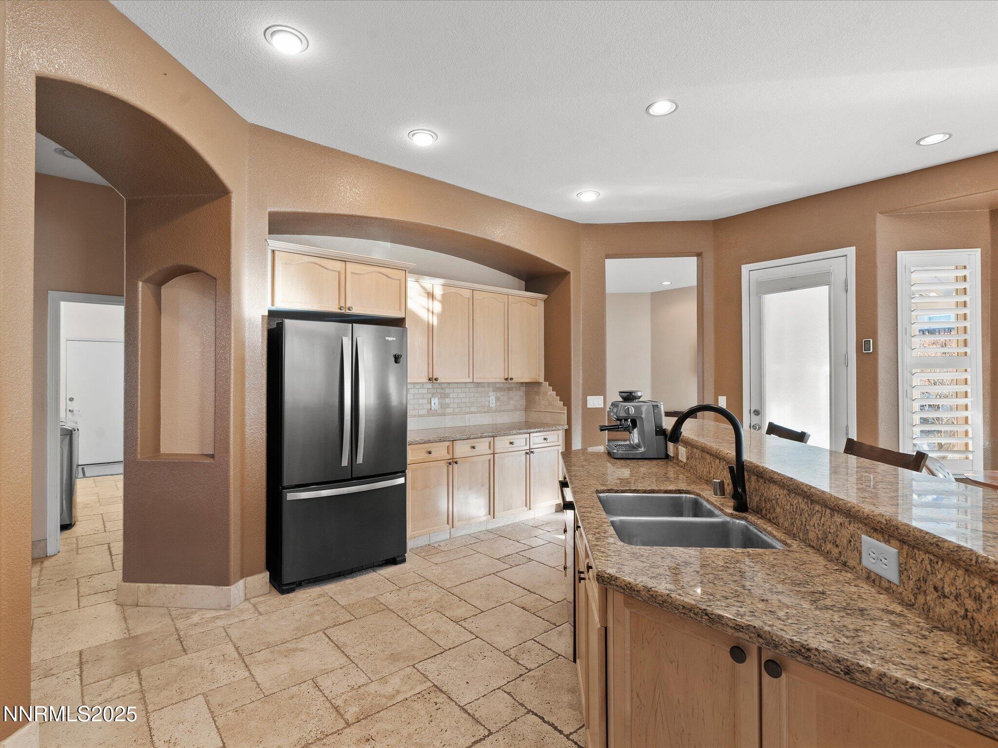 5519 New Mexico Court Reno, NV 89511 - Photo 22 of 60 a kitchen with stainless steel appliances granite countertop a refrigerator a sink and a stove