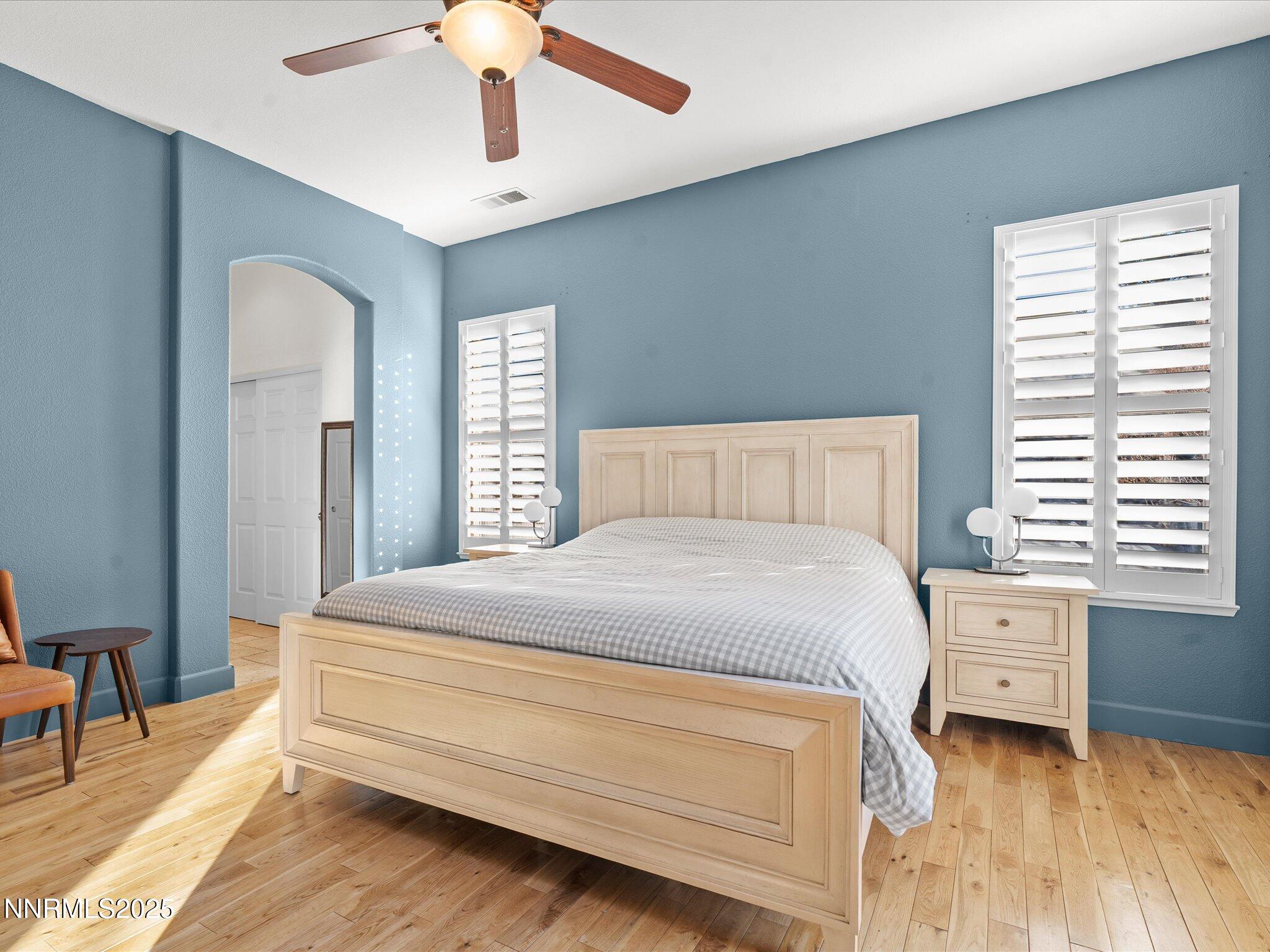 5519 New Mexico Court Reno, NV 89511 - Photo 25 of 60 a bedroom with a bed a chandelier and a window